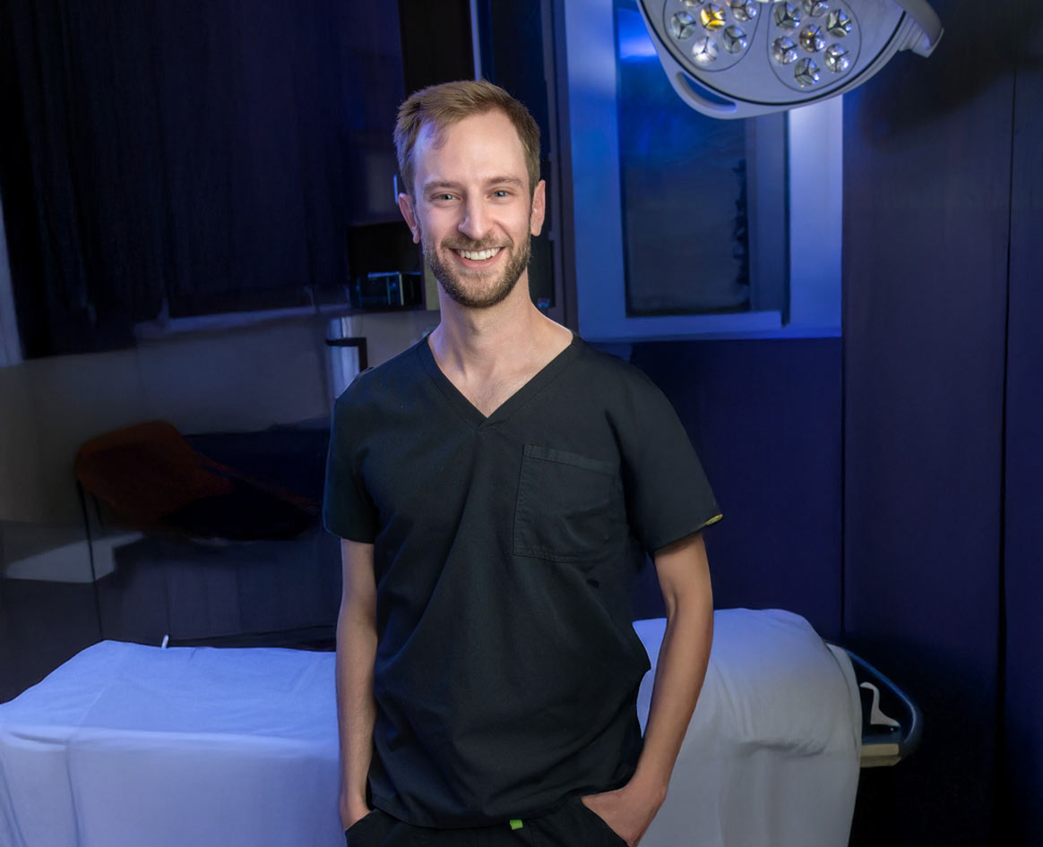 Dr. Freeman standing in operating room smiling